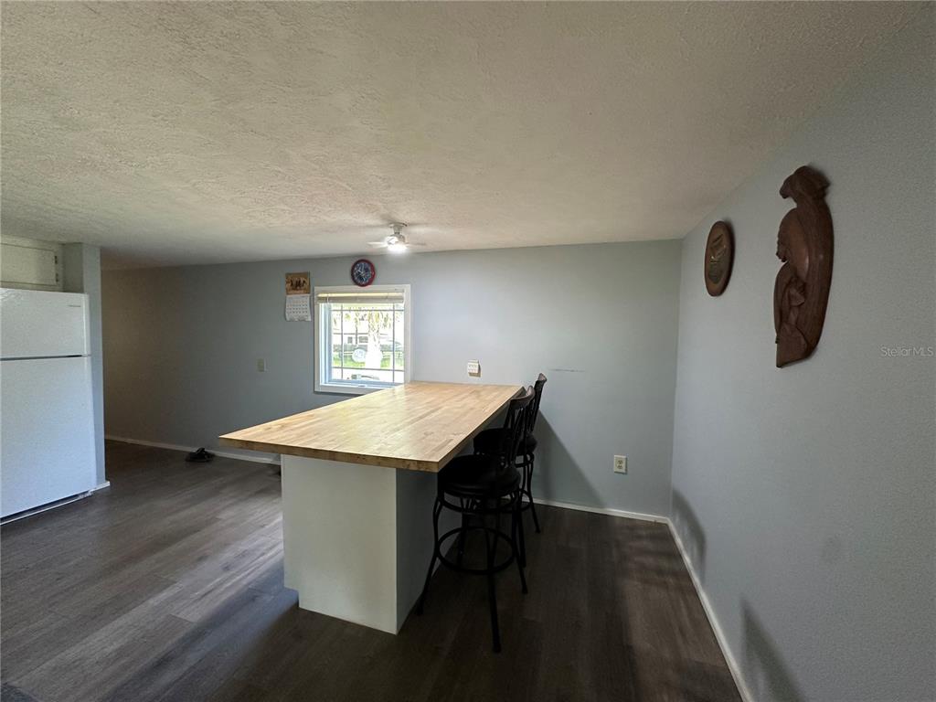 55045 6th Street Astor, FL 32102 - Photo 6 of 38 a workspace with wooden floor