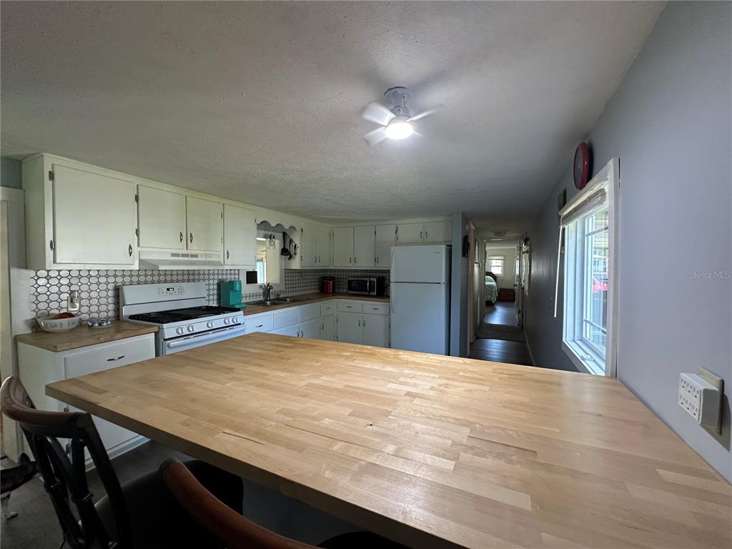 55045 6th Street Astor, FL 32102 - Photo 7 of 38 a large kitchen with stainless steel appliances a large counter top