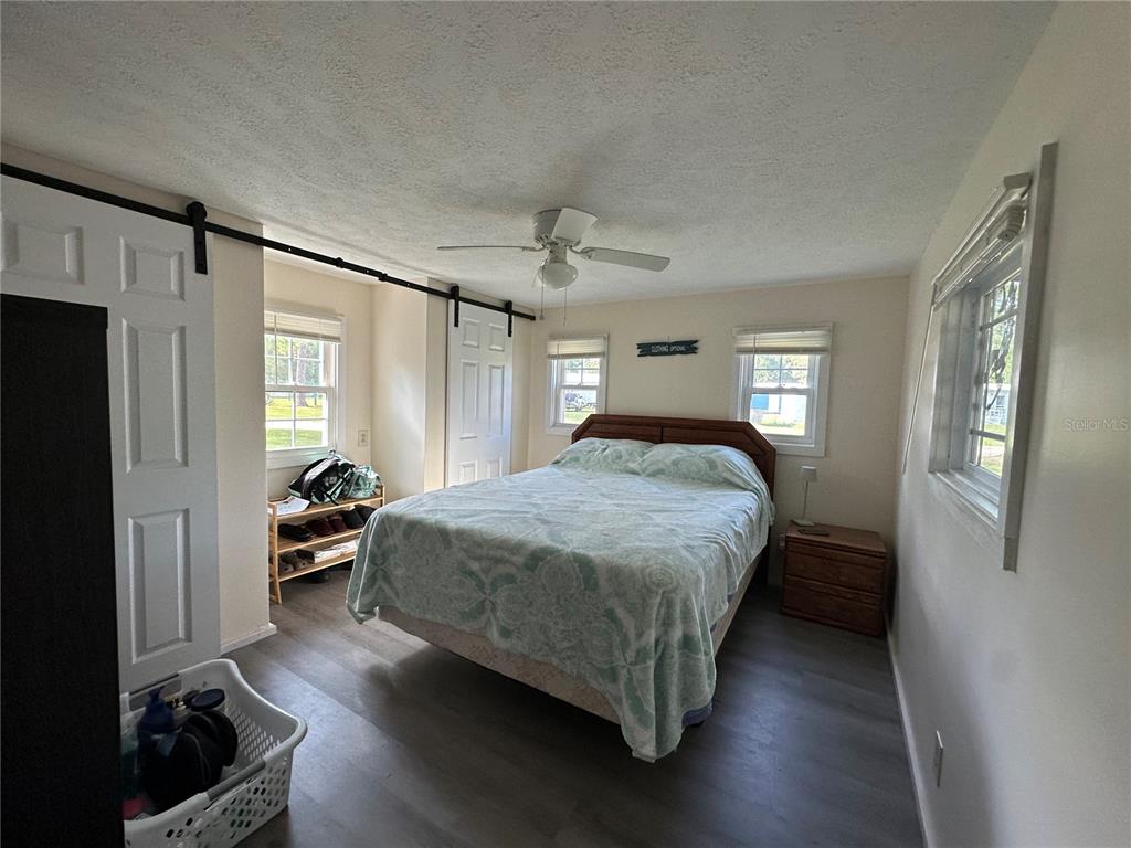 55045 6th Street Astor, FL 32102 - Photo 9 of 38 a bedroom with a bed and a chandelier