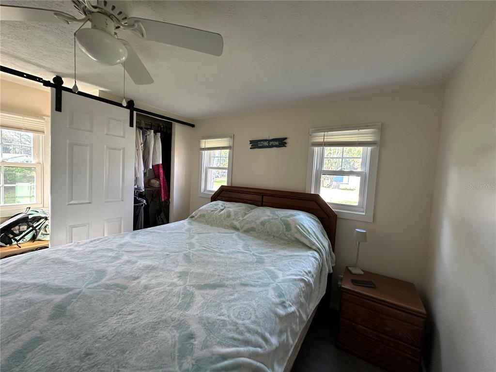55045 6th Street Astor, FL 32102 - Photo 10 of 38 a bedroom with a bed and a window