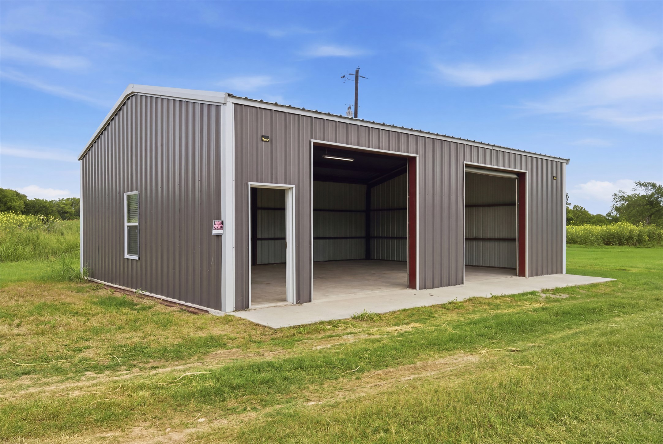 2043 Fm 971 Georgetown, TX 78626 - Photo 5 of 12 A spacious, constructed metal workshop provides ample storage and utility in a natural setting.