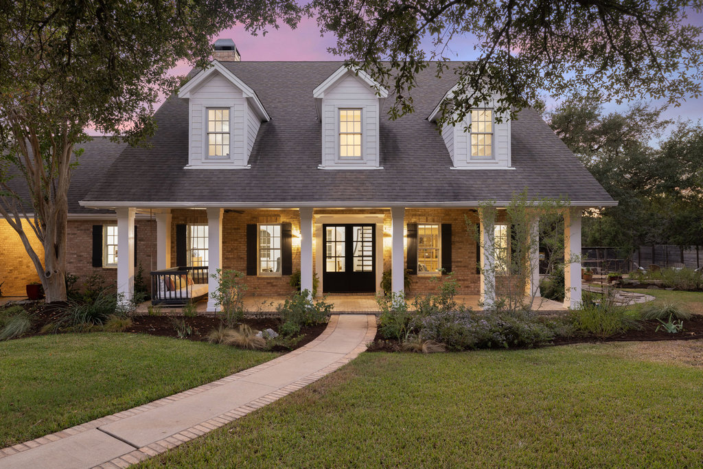 a front view of a house with garden
