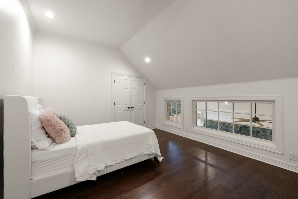 1350 Patterson Road Austin, TX 78733 - Photo 19 of 40 a bedroom with a large bed and a large window