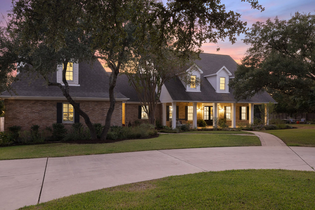 1350 Patterson Road Austin, TX 78733 - Photo 2 of 40 a front view of a house with a yard and garage