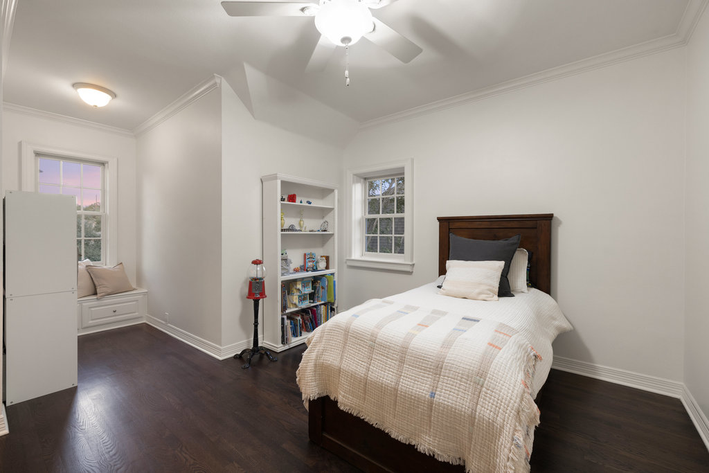 1350 Patterson Road Austin, TX 78733 - Photo 21 of 40 a bedroom with a bed and a book shelf