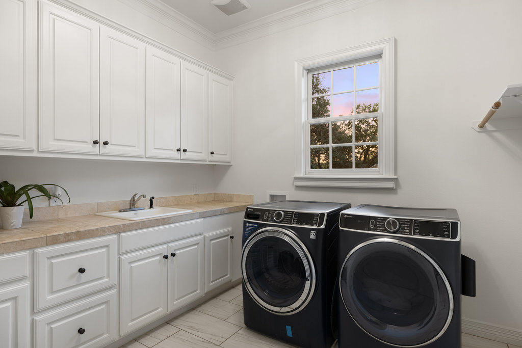 1350 Patterson Road Austin, TX 78733 - Photo 29 of 40 a utility room with sink dryer and washer