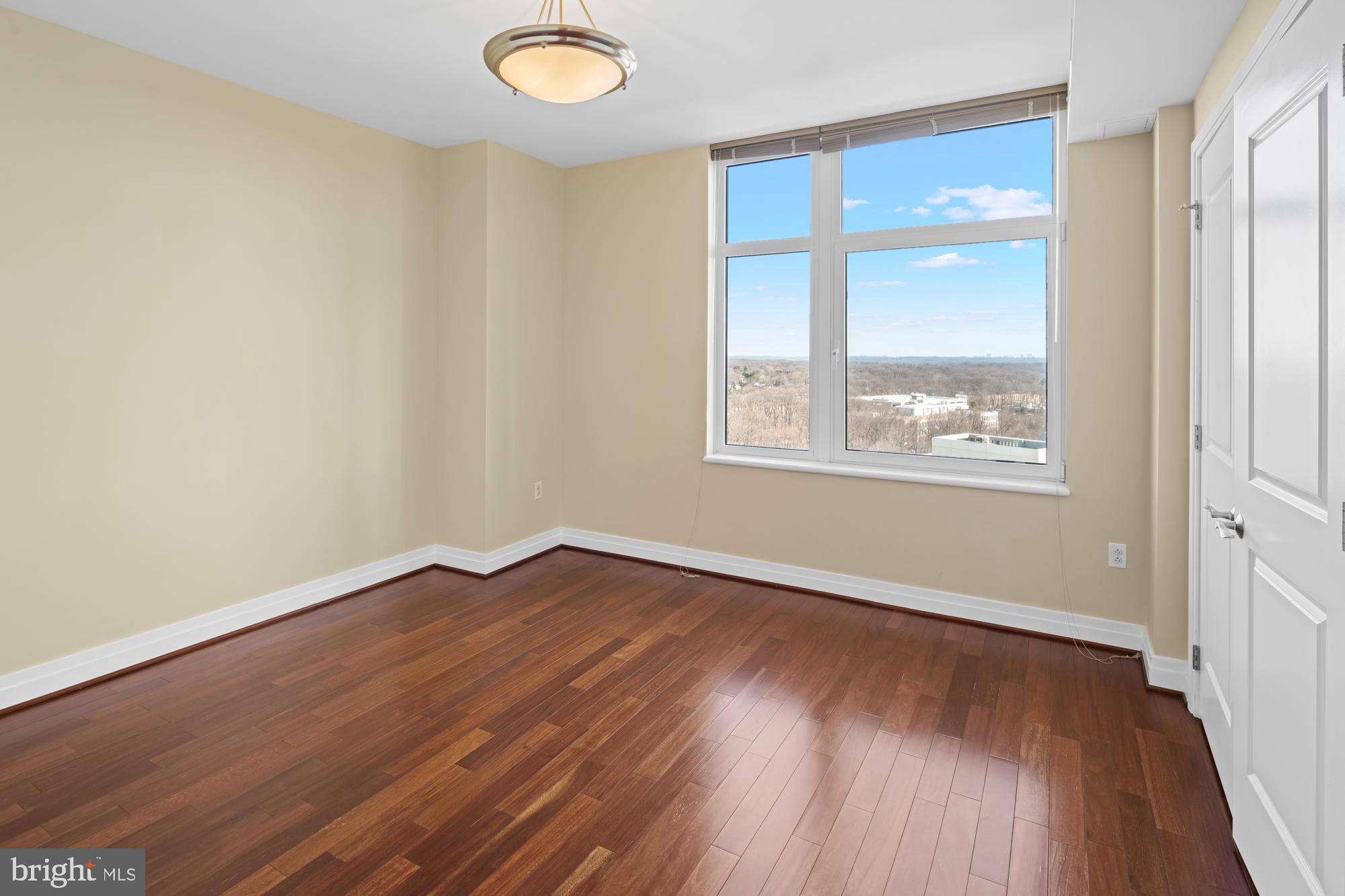 8220 Crestwood Heights Drive, Unit 1215 McLean, VA 22102 - Photo 24 of 59 an empty room with wooden floor and windows