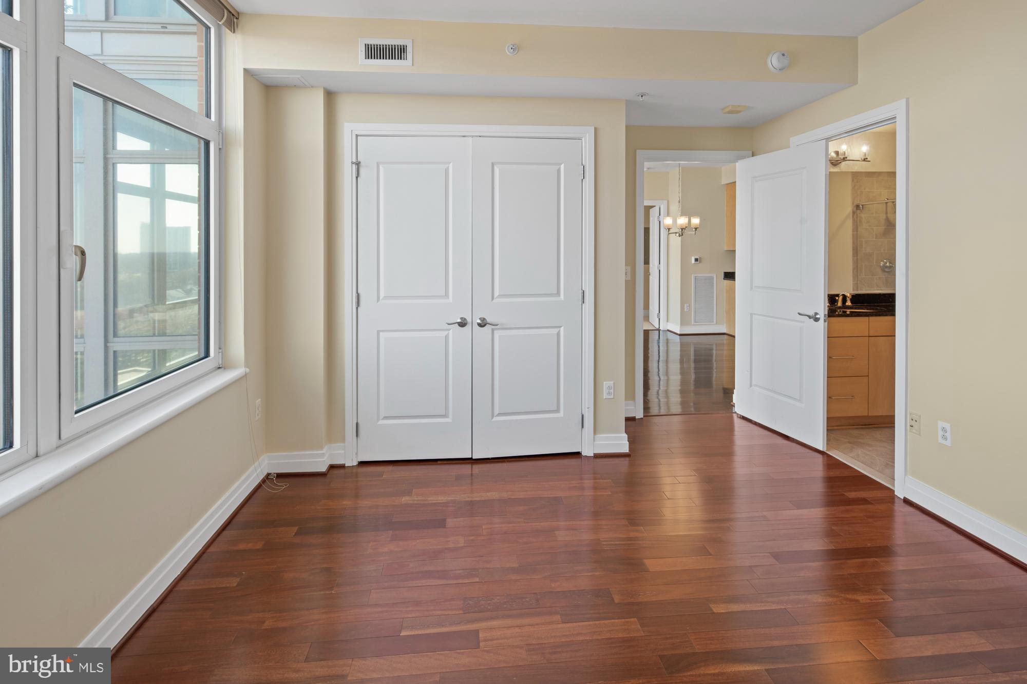 8220 Crestwood Heights Drive, Unit 1215 McLean, VA 22102 - Photo 26 of 59 a view of an empty room with wooden floor and a window