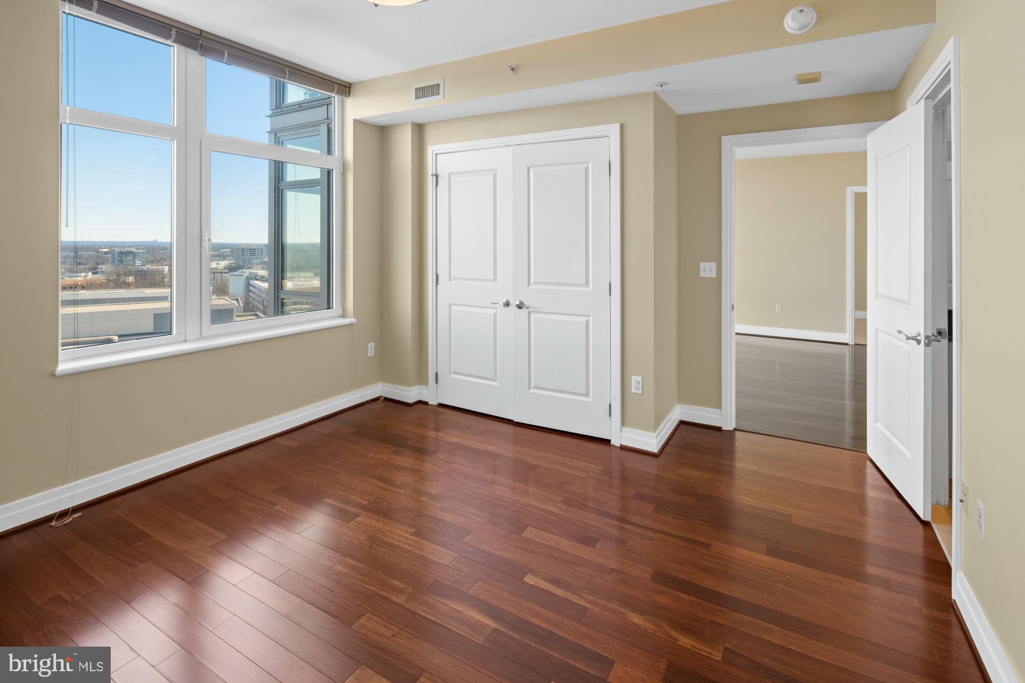 8220 Crestwood Heights Drive, Unit 1215 McLean, VA 22102 - Photo 27 of 59 a view of an empty room with wooden floor and a window