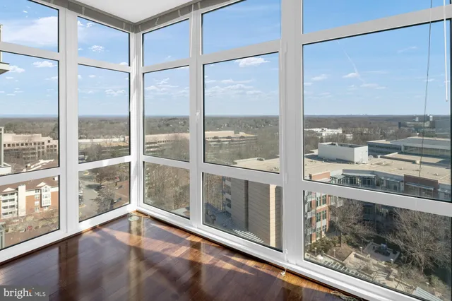 a kitchen with stainless steel appliances kitchen island granite countertop a dining table chairs and view living room
