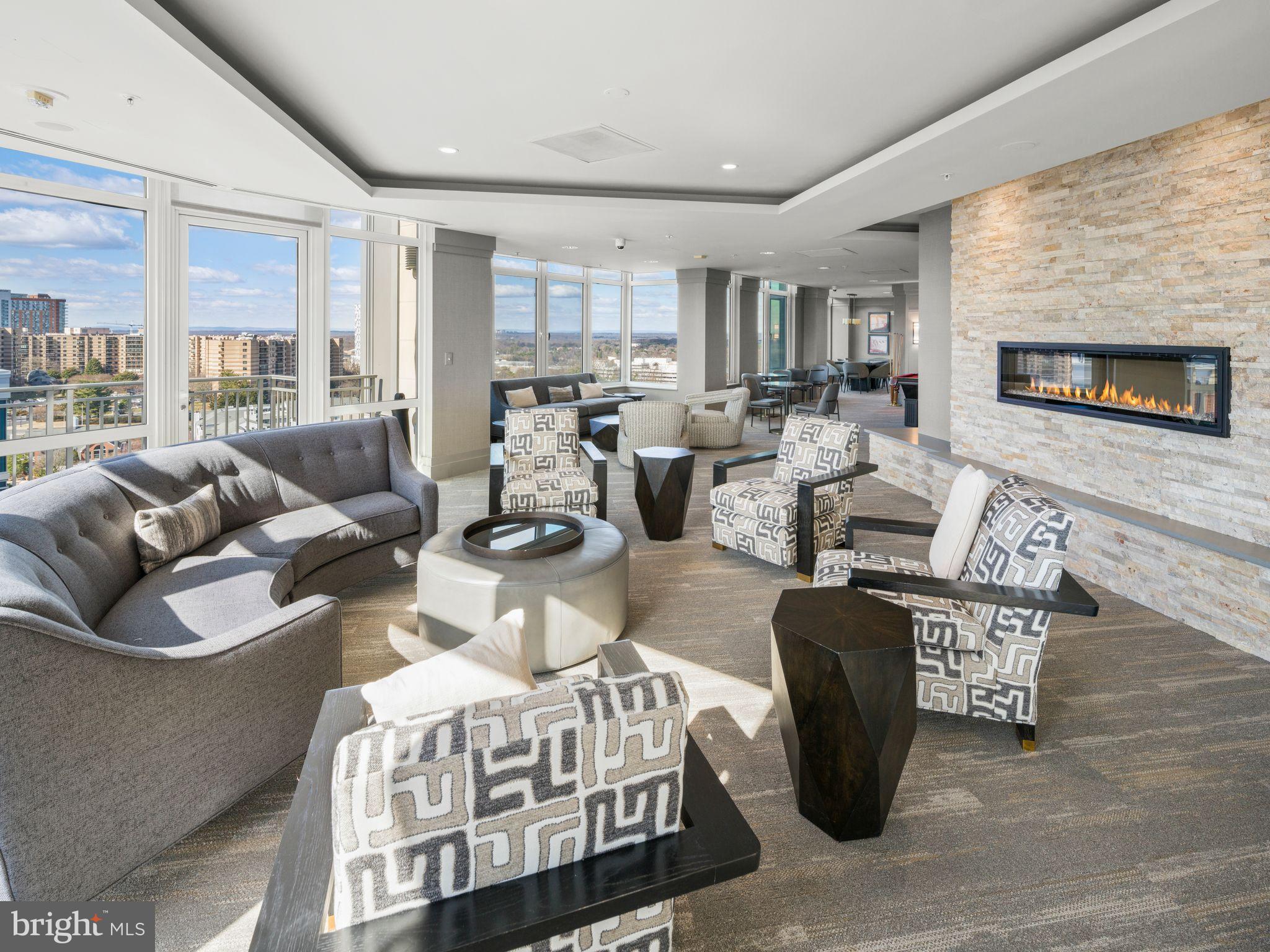 8220 Crestwood Heights Drive, Unit 1215 McLean, VA 22102 - Photo 39 of 59 a living room with furniture a fireplace and a flat screen tv