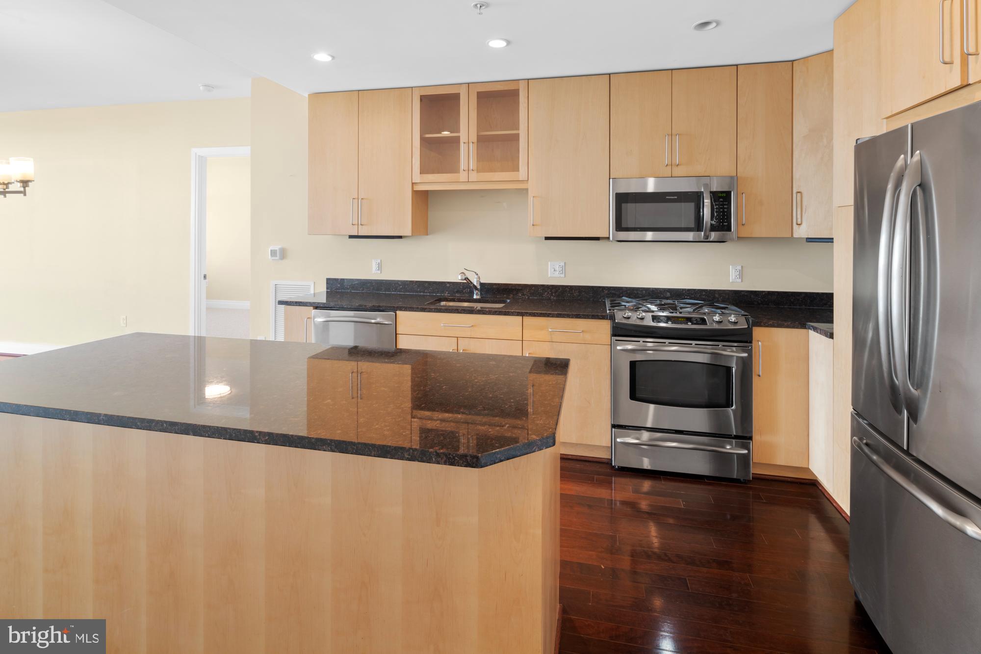 8220 Crestwood Heights Drive, Unit 1215 McLean, VA 22102 - Photo 8 of 59 a kitchen with stainless steel appliances granite countertop a stove a sink and a microwave