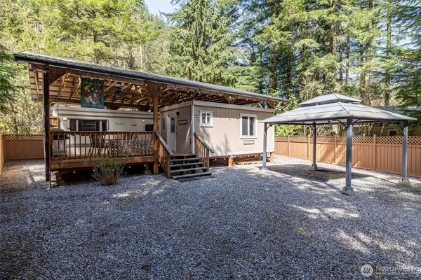 a view of a house with a yard and sitting area