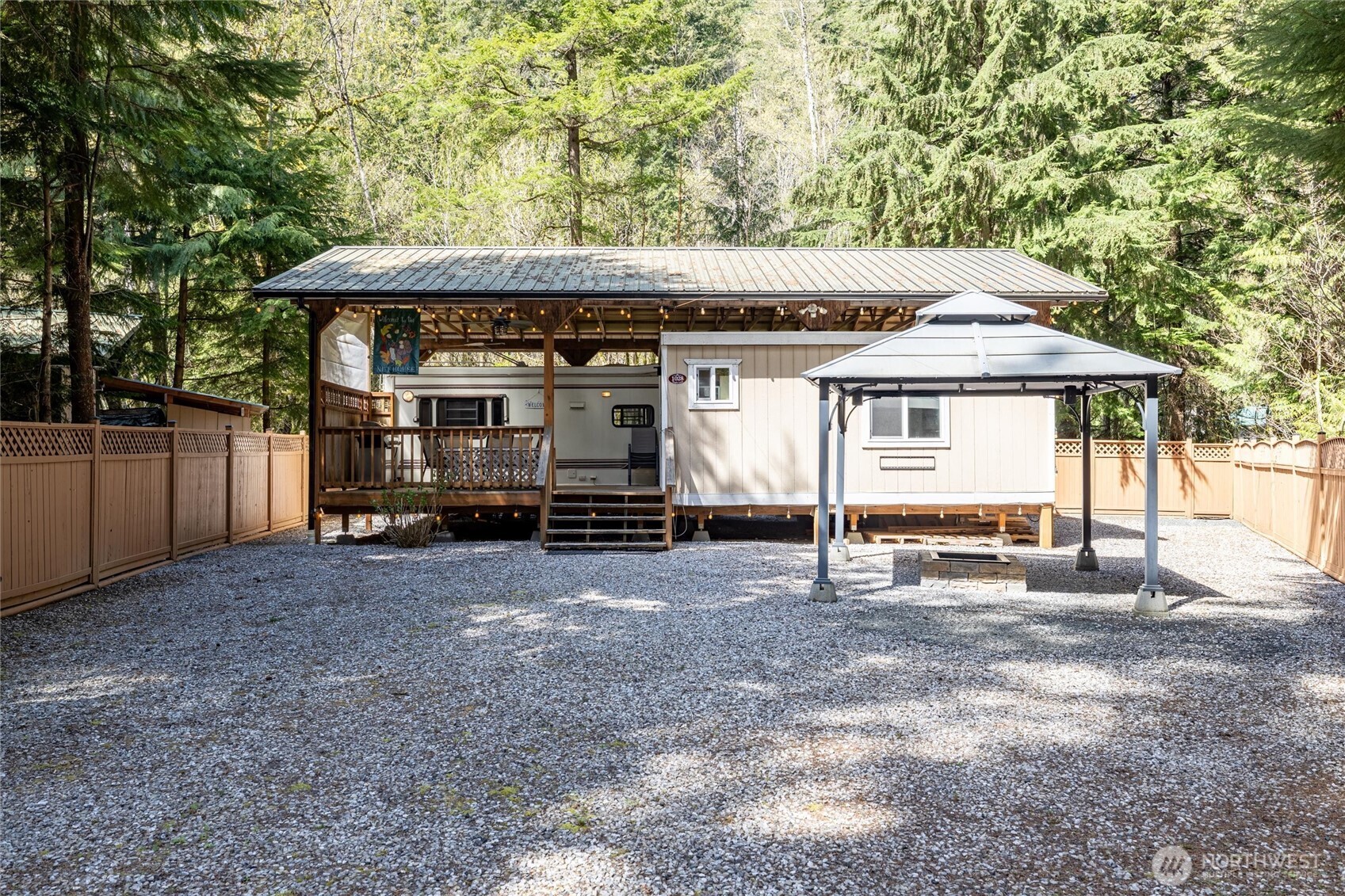 1028 Maple Lane Maple Falls, WA 98266 - Photo 16 of 17 a view of a house with a bed and a table under an umbrella