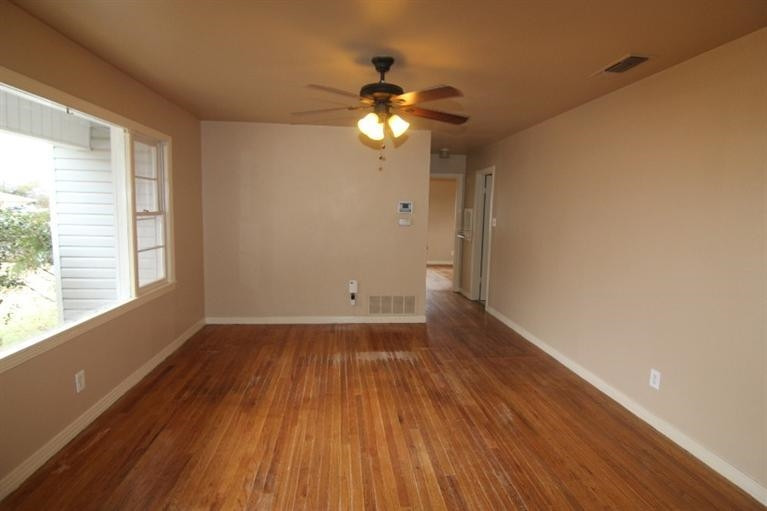4407 37th Street Lubbock, TX 79414 - Photo 2 of 10 a view of empty room with wooden floor and fan