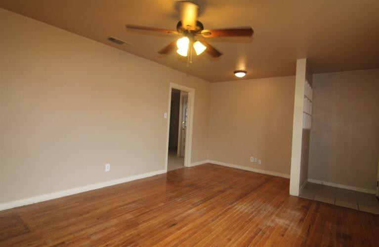 4407 37th Street Lubbock, TX 79414 - Photo 3 of 10 a view of an empty room with wooden floor