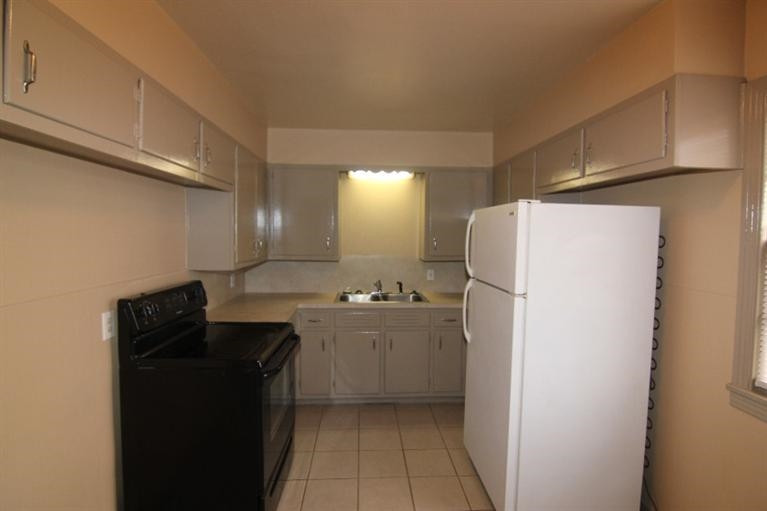4407 37th Street Lubbock, TX 79414 - Photo 5 of 10 a kitchen with a refrigerator and a sink
