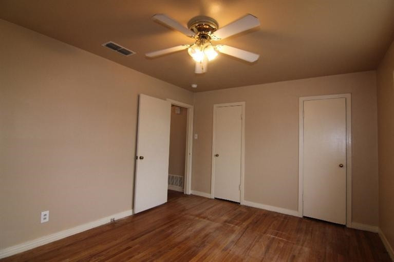 4407 37th Street Lubbock, TX 79414 - Photo 7 of 10 a view of an empty room with wooden floor and a ceiling fan