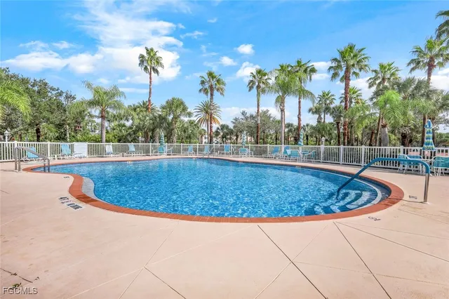 a view of a swimming pool with an outdoor space and seating area