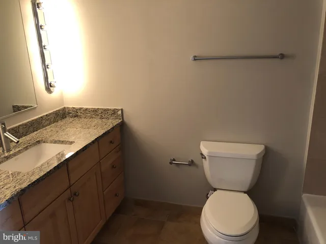 a white toilet sitting next to a bathroom sink
