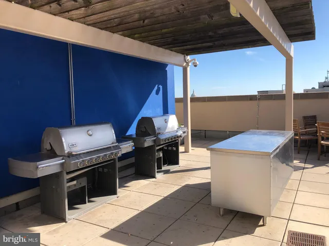 a kitchen with a stove top oven and cabinets