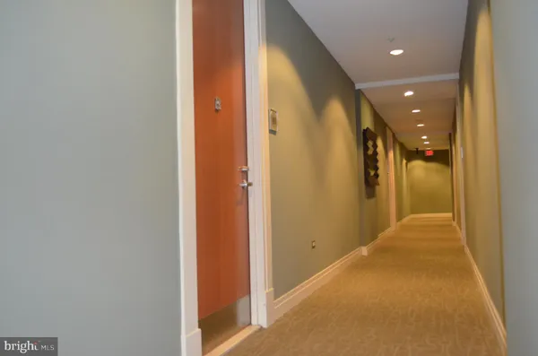 a view of a hallway with a bathroom
