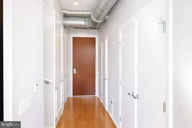 a view of a hallway with wooden floor