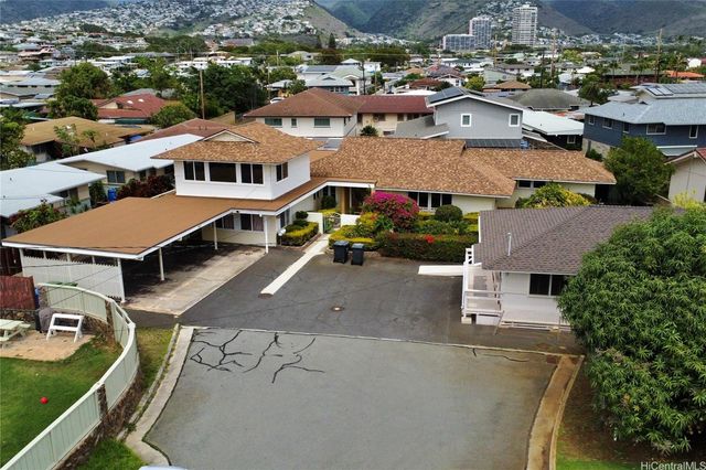 an aerial view of multiple houses with yard