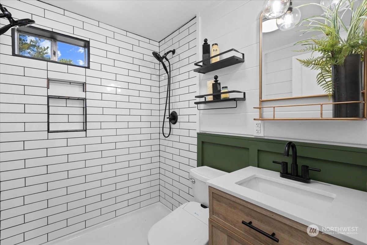 3304 Southeast 6th Street Renton, WA 98058 - Photo 11 of 30 a bathroom with a sink a toilet and mirror