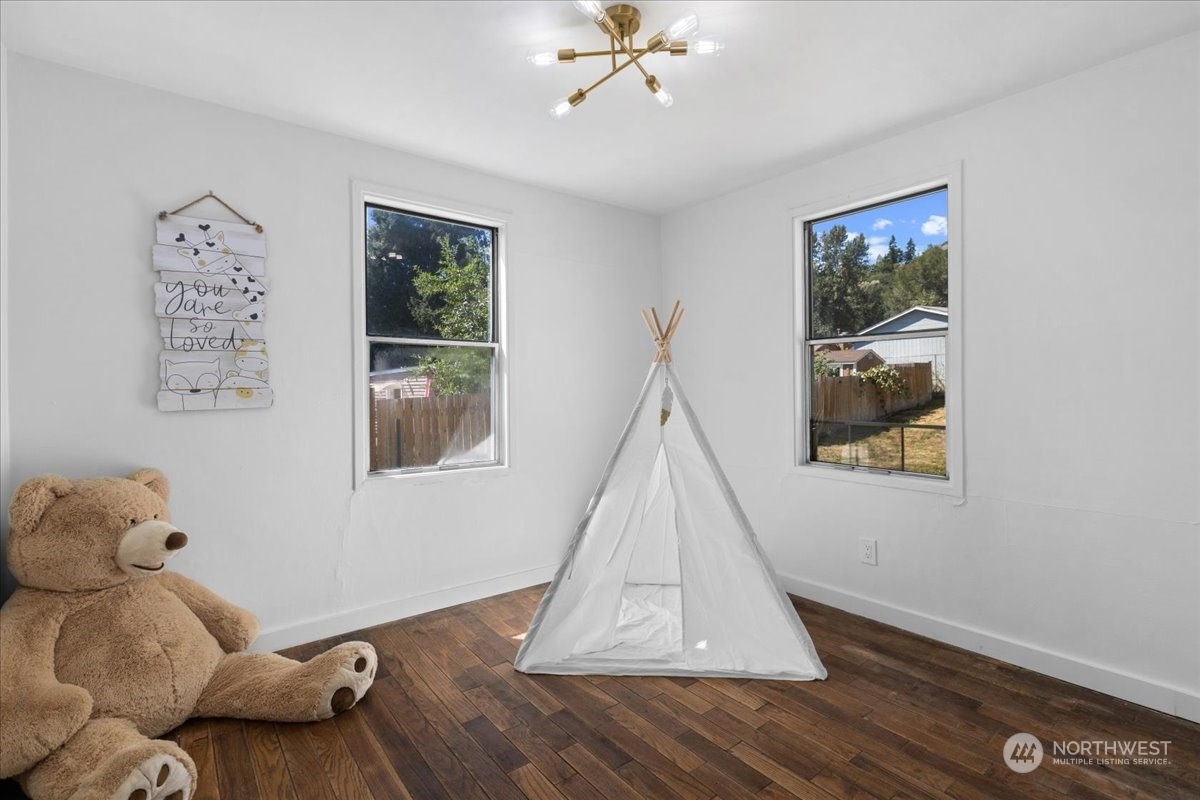 3304 Southeast 6th Street Renton, WA 98058 - Photo 12 of 30 a room with window and a wooden floor