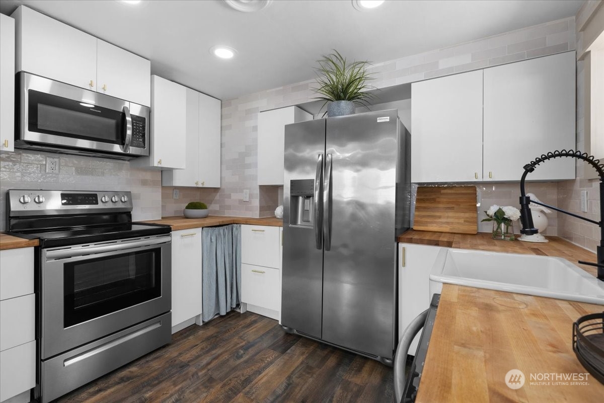 3304 Southeast 6th Street Renton, WA 98058 - Photo 18 of 30 a kitchen with stainless steel appliances a refrigerator sink and microwave