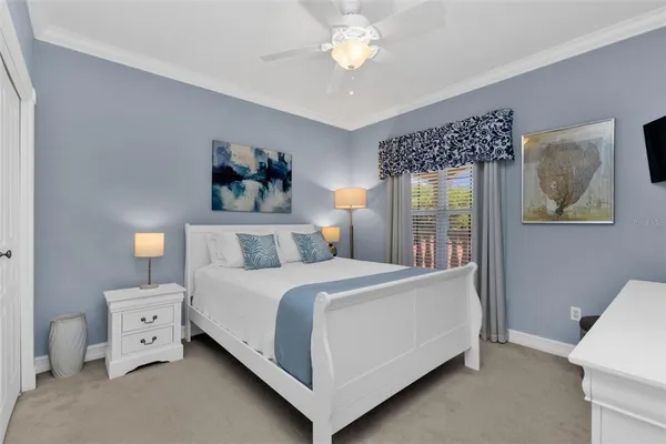 a bedroom with a large bed and a chandelier