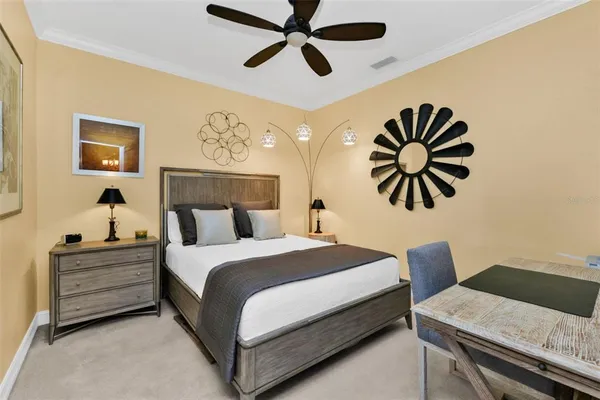 a bedroom with a bed and a chandelier