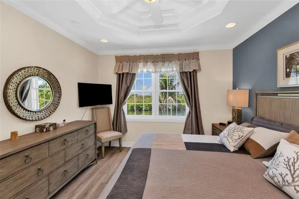 a living room with furniture a window and a flat screen tv