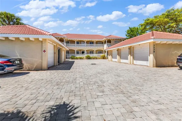 a view of a white house with a yard