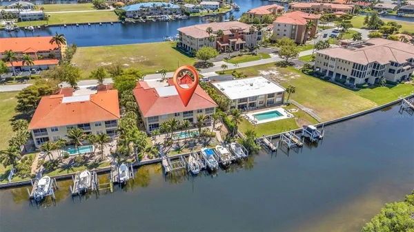 an aerial view of residential houses with outdoor space and parking