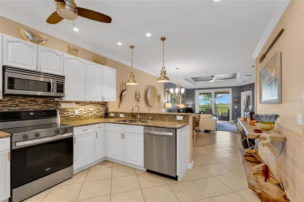 a kitchen with stainless steel appliances granite countertop a sink and a stove