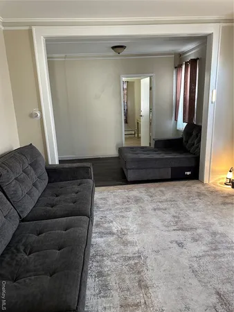 a living room with a couch and a large mirror