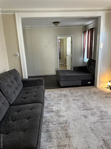 a living room with a couch and a large mirror