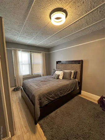 a bedroom with a bed and a large window