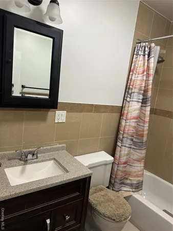 a bathroom with a sink a toilet and mirror