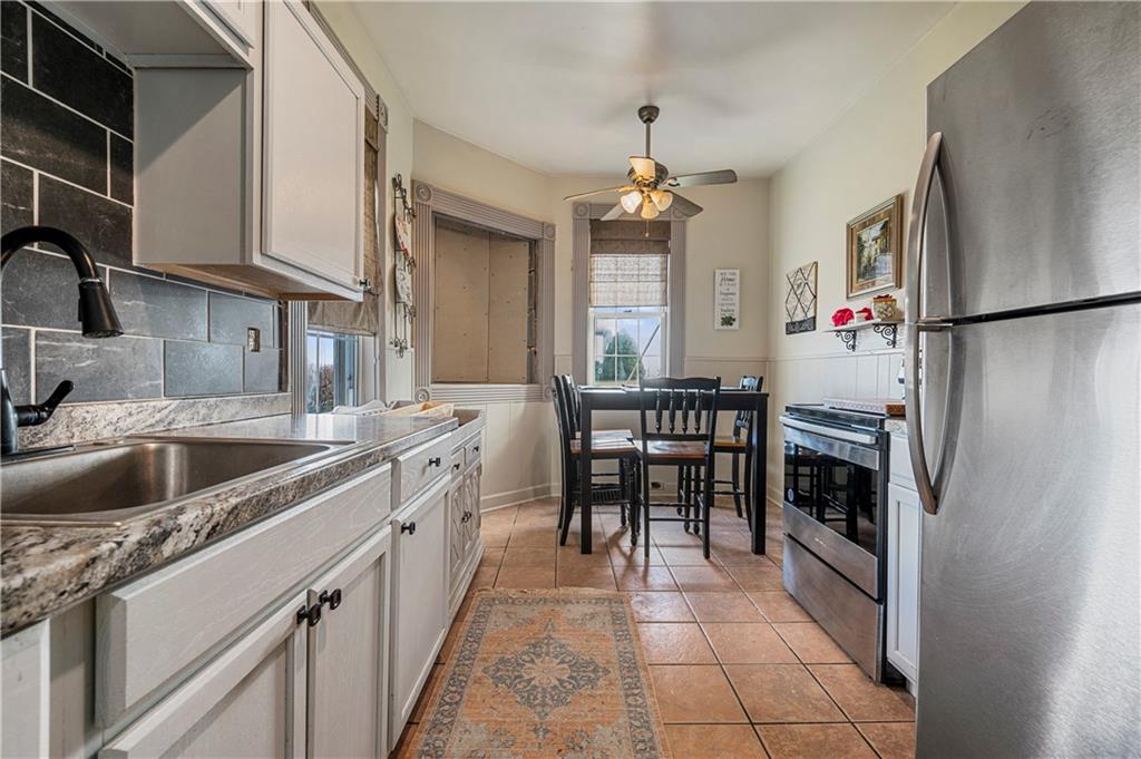 2099 Marshall Road Monaca, PA 15061 - Photo 6 of 24 a kitchen with a sink stainless steel appliances a counter top space and cabinets