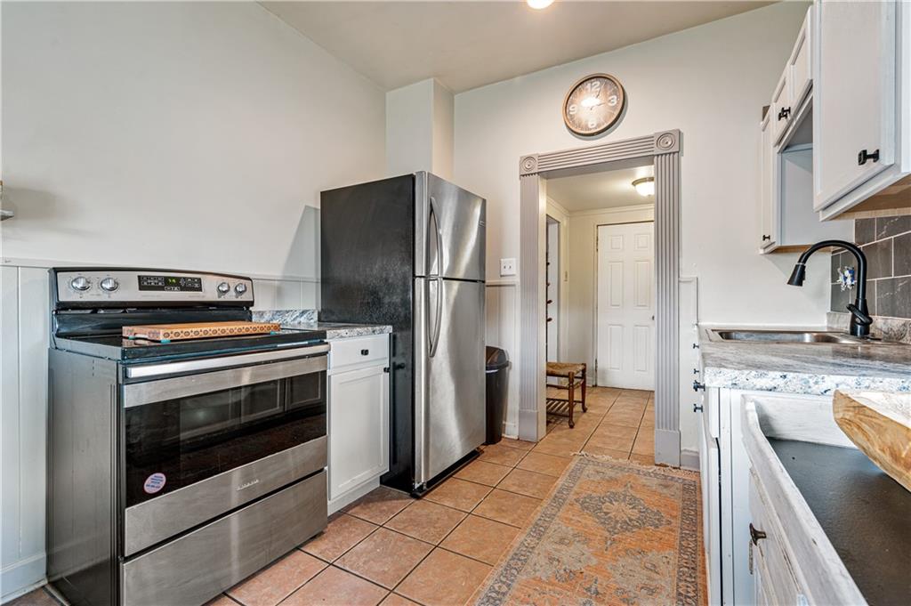 2099 Marshall Road Monaca, PA 15061 - Photo 9 of 24 a kitchen with a stove and a refrigerator