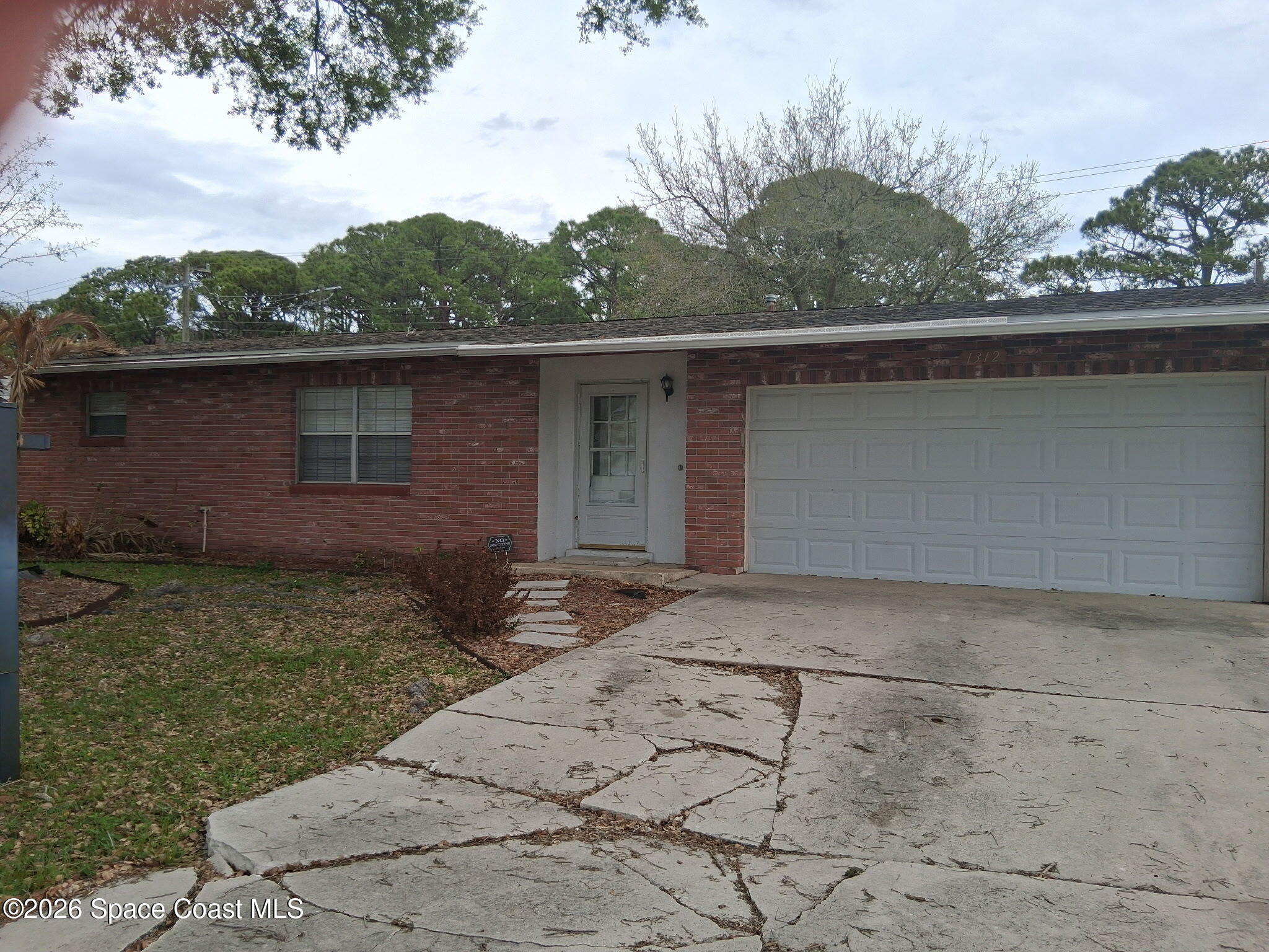 1312 Huntington Lane Rockledge, FL 32955 - Photo 2 of 21 front view of a house with a yard