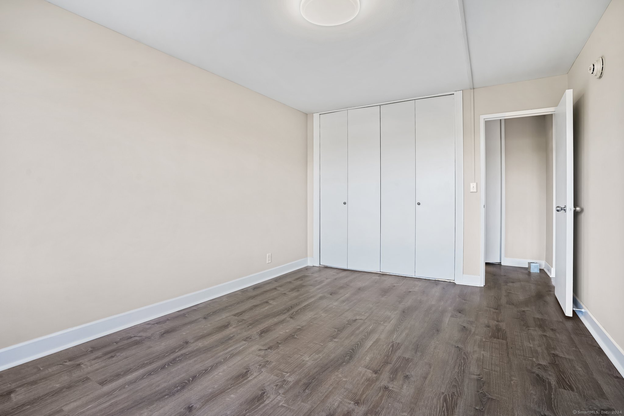 2625 Park Avenue, Unit 6M Bridgeport, CT 06604 - Photo 13 of 21 a view of an empty room with wooden floor