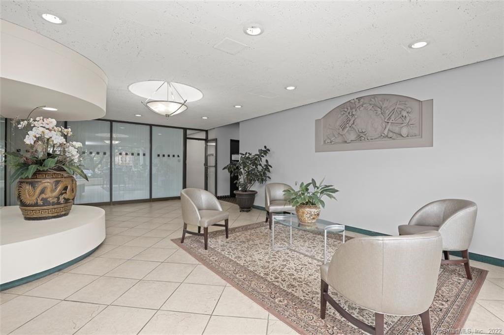 2625 Park Avenue, Unit 6M Bridgeport, CT 06604 - Photo 14 of 21 a living room with furniture and a chandelier