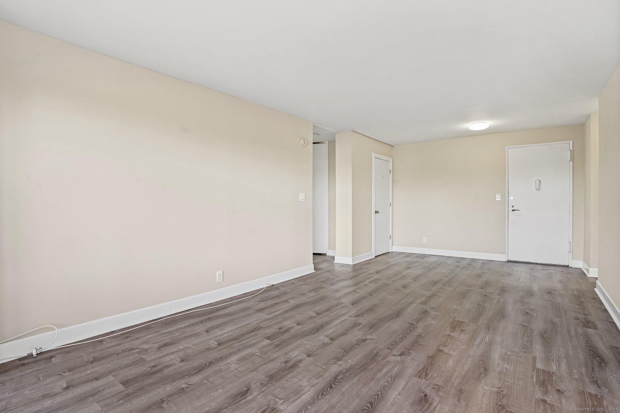 2625 Park Avenue, Unit 6M Bridgeport, CT 06604 - Photo 10 of 21 a view of an empty room and wooden floor