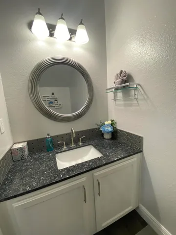 a bathroom with a sink a toilet and a shower