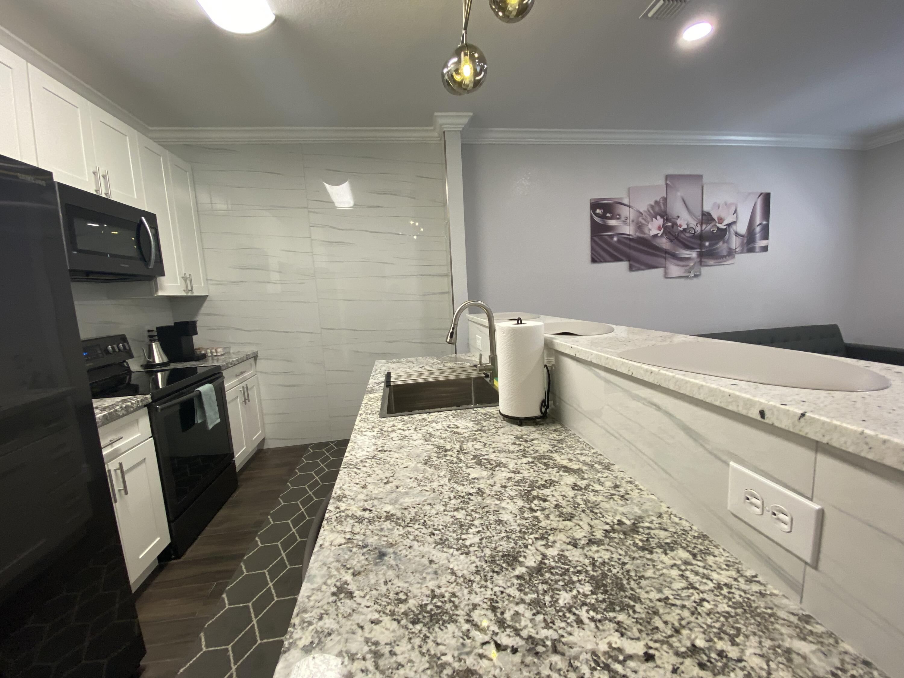 1014 Airport Road, Unit 105 Destin, FL 32541 - Photo 12 of 12 a bathroom with a sink a toilet and a shower