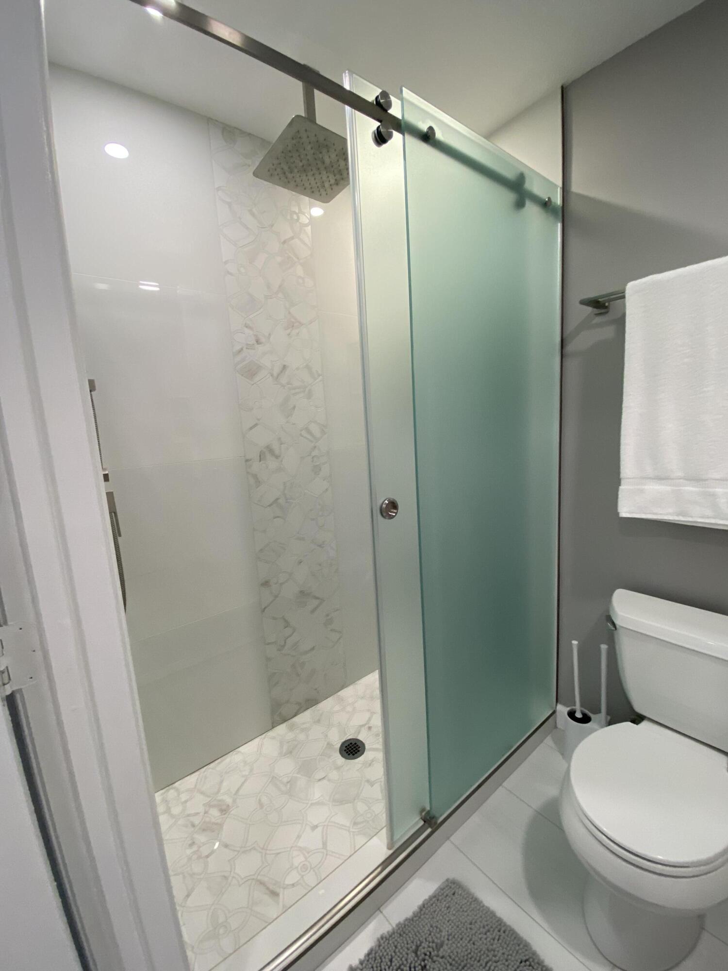 1014 Airport Road, Unit 105 Destin, FL 32541 - Photo 5 of 12 a bathroom with a shower and a toilet
